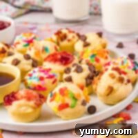 A plate piled high with mini pancake bites, some with chocolate chips, ready to eat.