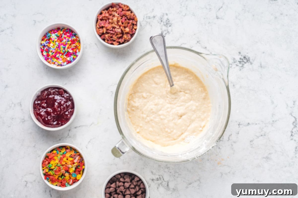 Light, fluffy pancake batter in a mixing bowl, ready for the muffin tin.