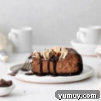 Decadent mocha cheesecake with an Oreo crust, topped with whipped cream.