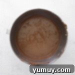 Decadent chocolate cheesecake batter in a mixing bowl, ready for the eggs.