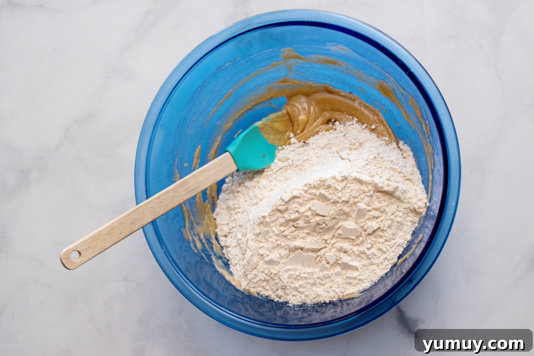 Golden Brown Sugar Delights 7 Cookie dough ingredients being mixed in a bowl, showcasing the transition from dry to wet.