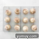 Decadent Tiramisu Cupcakes 11 12 cocoa powder dusted tiramisu cupcakes on a cooling rack.