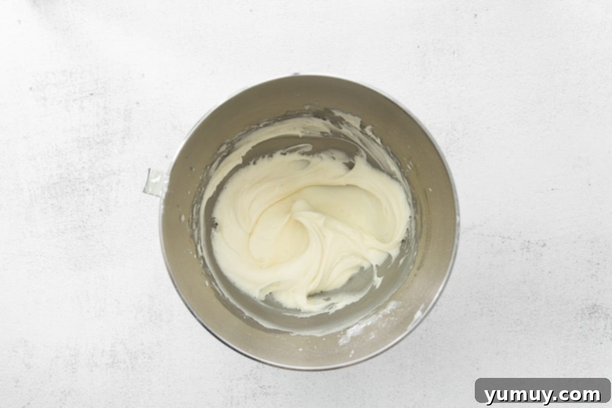 Decadent Tiramisu Cupcakes 16 mascarpone frosting in a stainless mixing bowl.