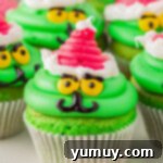 a plate of grinch cupcakes