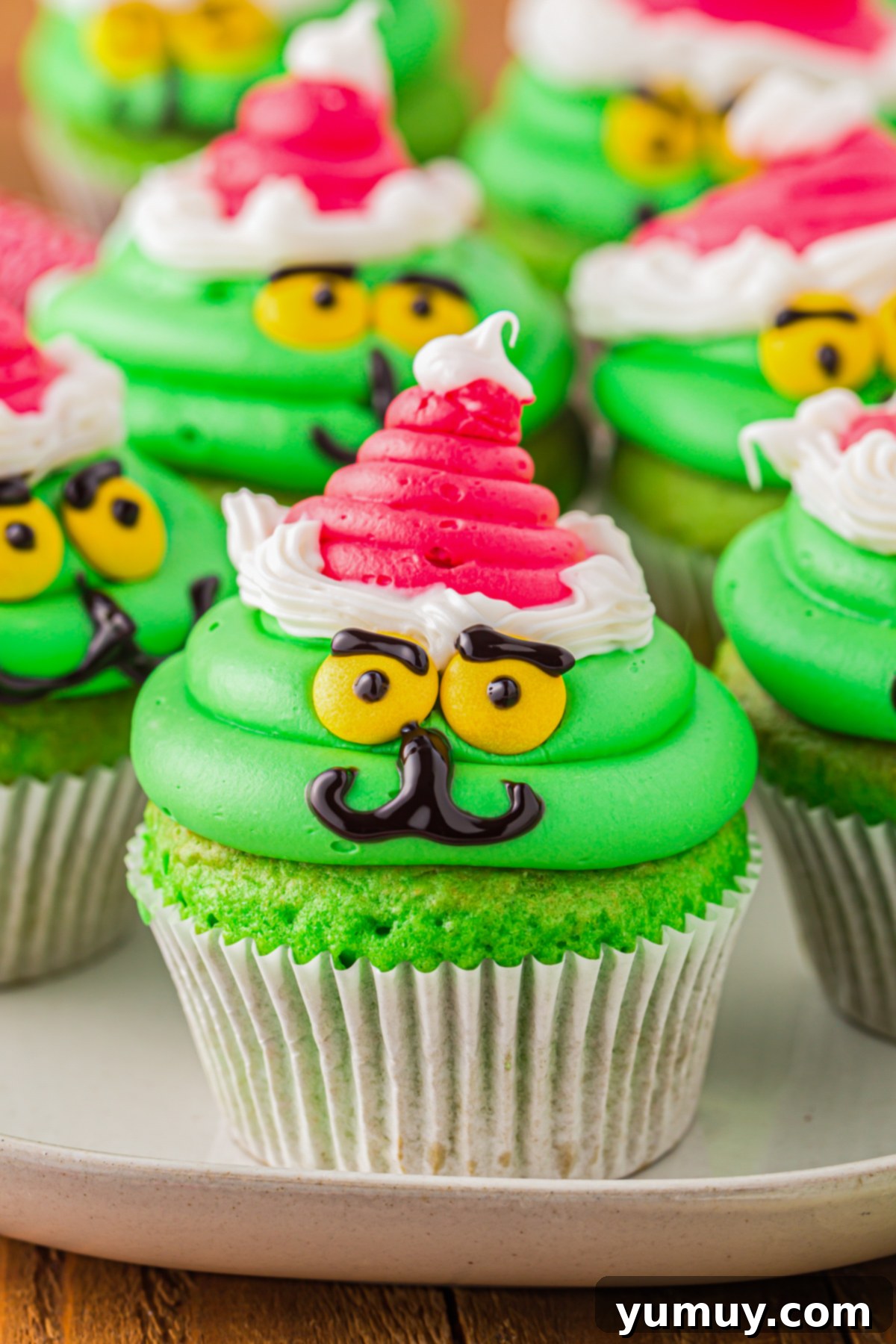 a plate of grinch cupcakes
