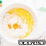 combining cupcake ingredients in a bowl