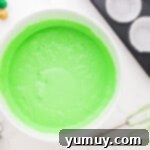 a bowl of green cupcake batter