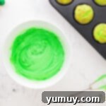 a bowl of neon green dyed frosting