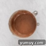 Decadent Chocolate Strawberry Delight 5 A bowl of rich brown cake batter, perfectly mixed and ready for the oven, showcasing its smooth consistency.