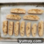 sliced maple pecan biscotti on a baking sheet.