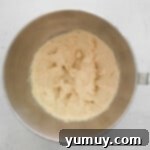 creamed butter, sugar, and maple syrup in a stainless mixing bowl.