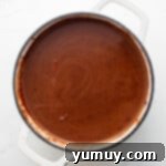 overhead view of mexican hot chocolate in a white dutch oven.