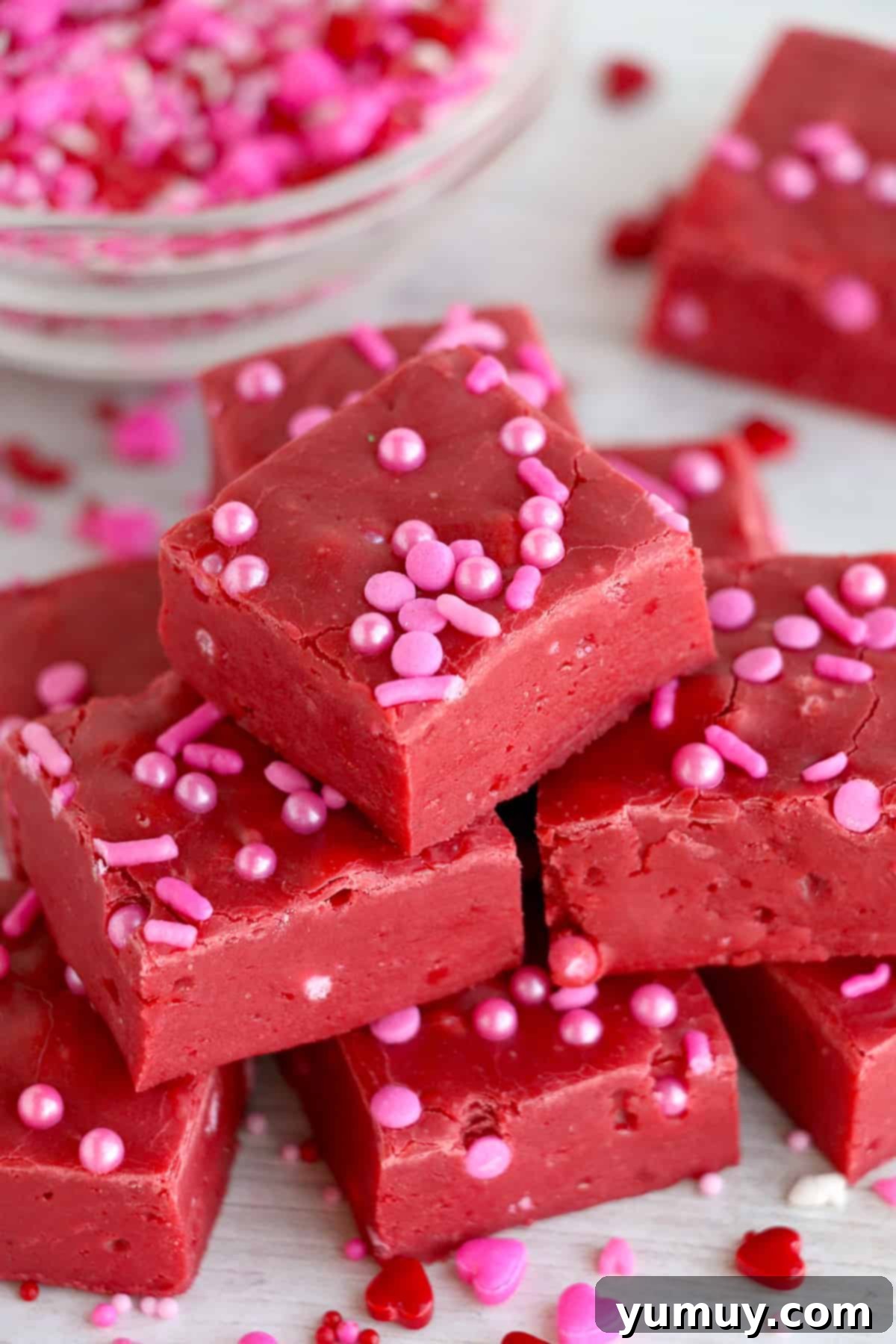 red velvet fudge pieces on platter topped with pink sprinkles.
