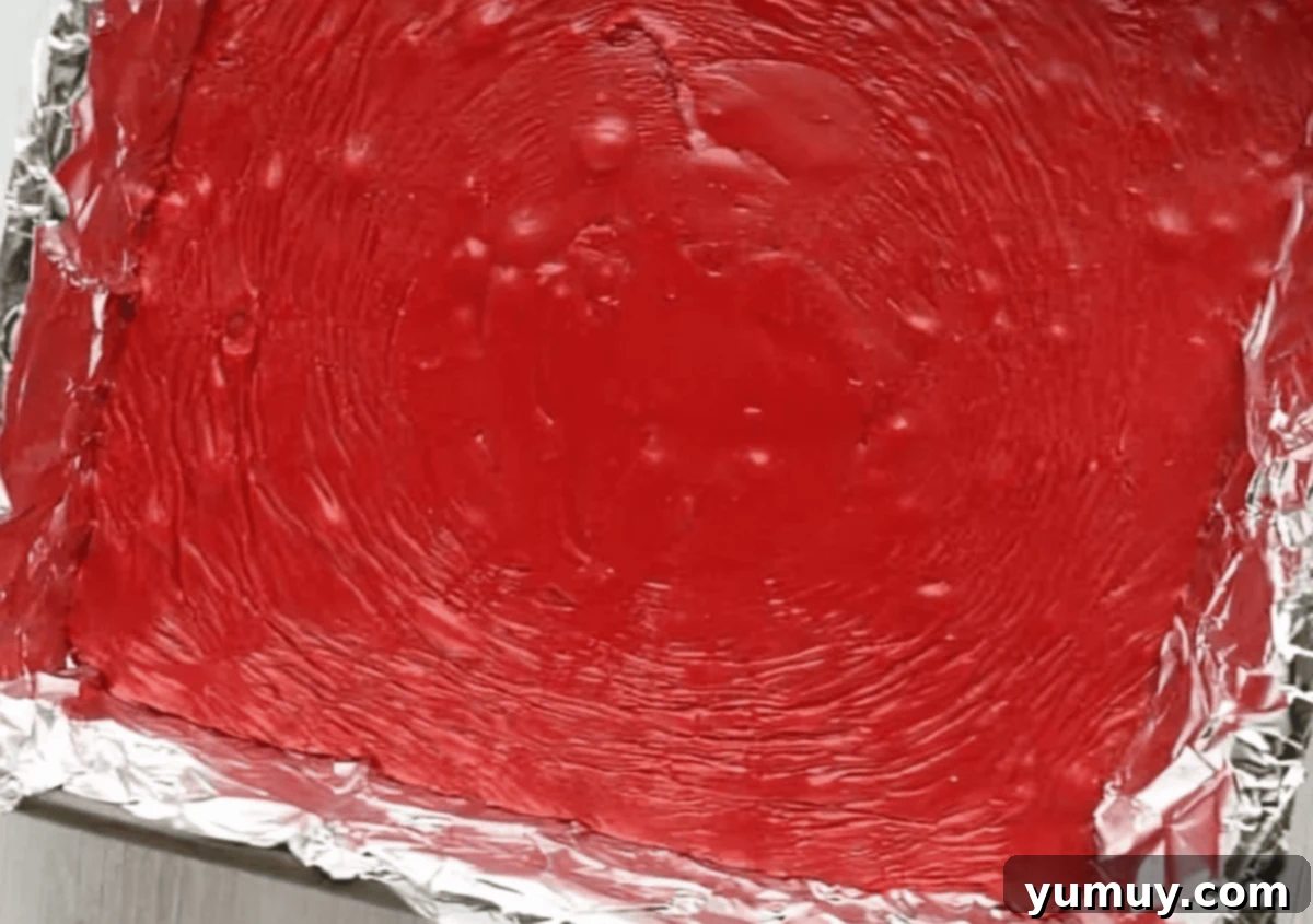 red velvet fudge in a lined baking pan.