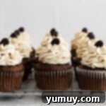 Nine elegantly frosted Kahlua cupcakes, arranged artfully on a cooling wire rack.