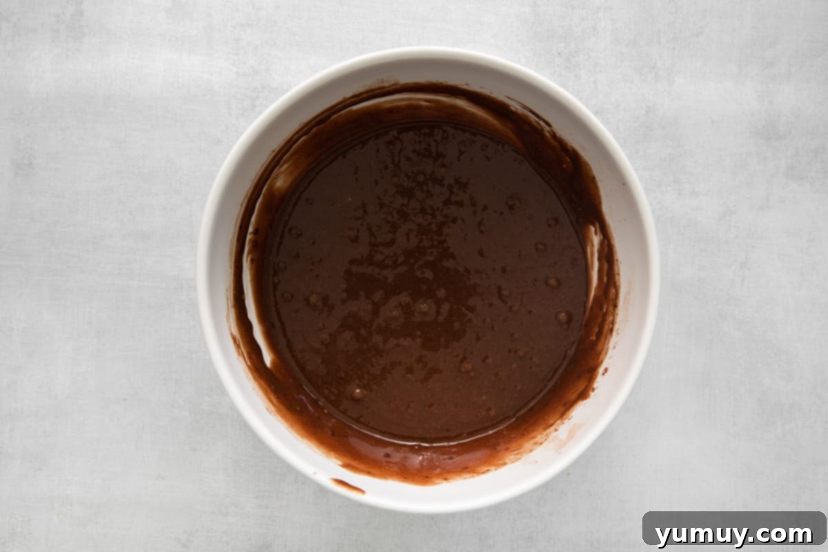 Kahlua cupcake batter expertly prepared in a pristine white bowl, ready for baking.