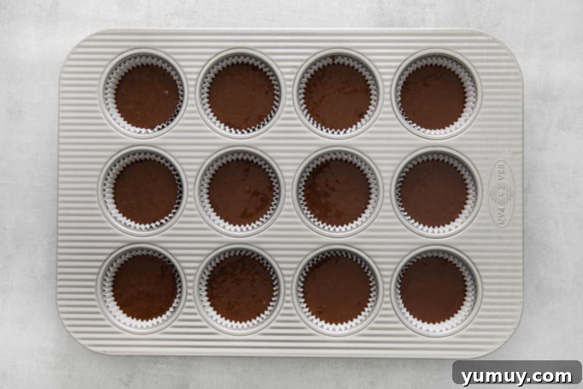 Kahlua cupcake batter neatly portioned into a cupcake tin, ready for the oven.
