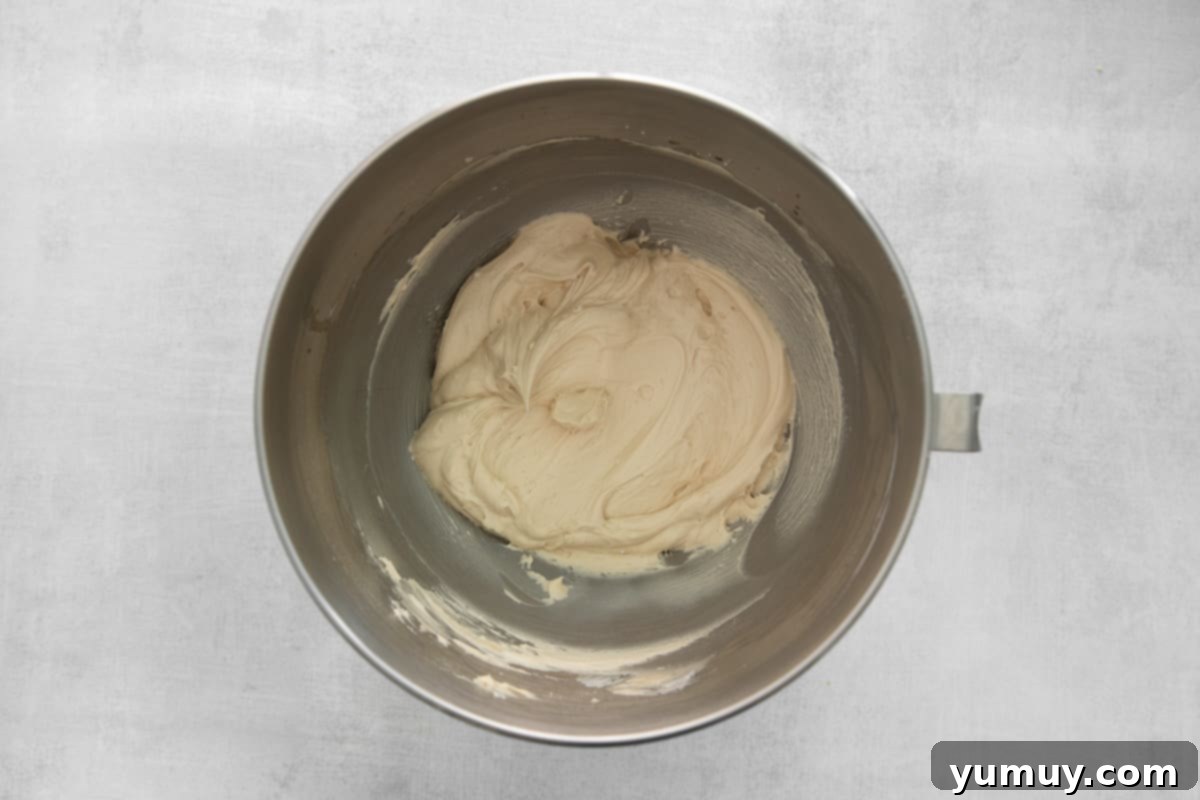 Smooth and fluffy Kahlua buttercream, beautifully prepared in a gleaming stainless steel mixing bowl.