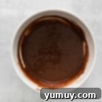 Kahlua cupcake batter expertly prepared in a pristine white bowl, ready for baking.