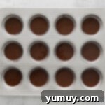 Kahlua cupcake batter neatly portioned into a cupcake tin, ready for the oven.