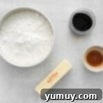 Overhead view of the meticulously arranged ingredients for Kahlua buttercream in elegant white and clear glass bowls.