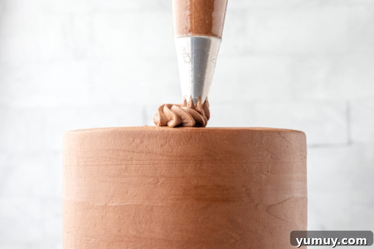 Dark Chocolate Raspberry Gateau 16 frosting piped on a frosted chocolate raspberry layer cake.