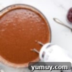 Dark Chocolate Raspberry Gateau 5 chocolate cake batter in a glass bowl with a hand mixer.
