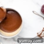 Dark Chocolate Raspberry Gateau 6 chocolate cake batter poured into a cake pan next to hand mixer beaters.