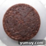 Dark Chocolate Raspberry Gateau 7 a layer of chocolate cake on a gray cake board.