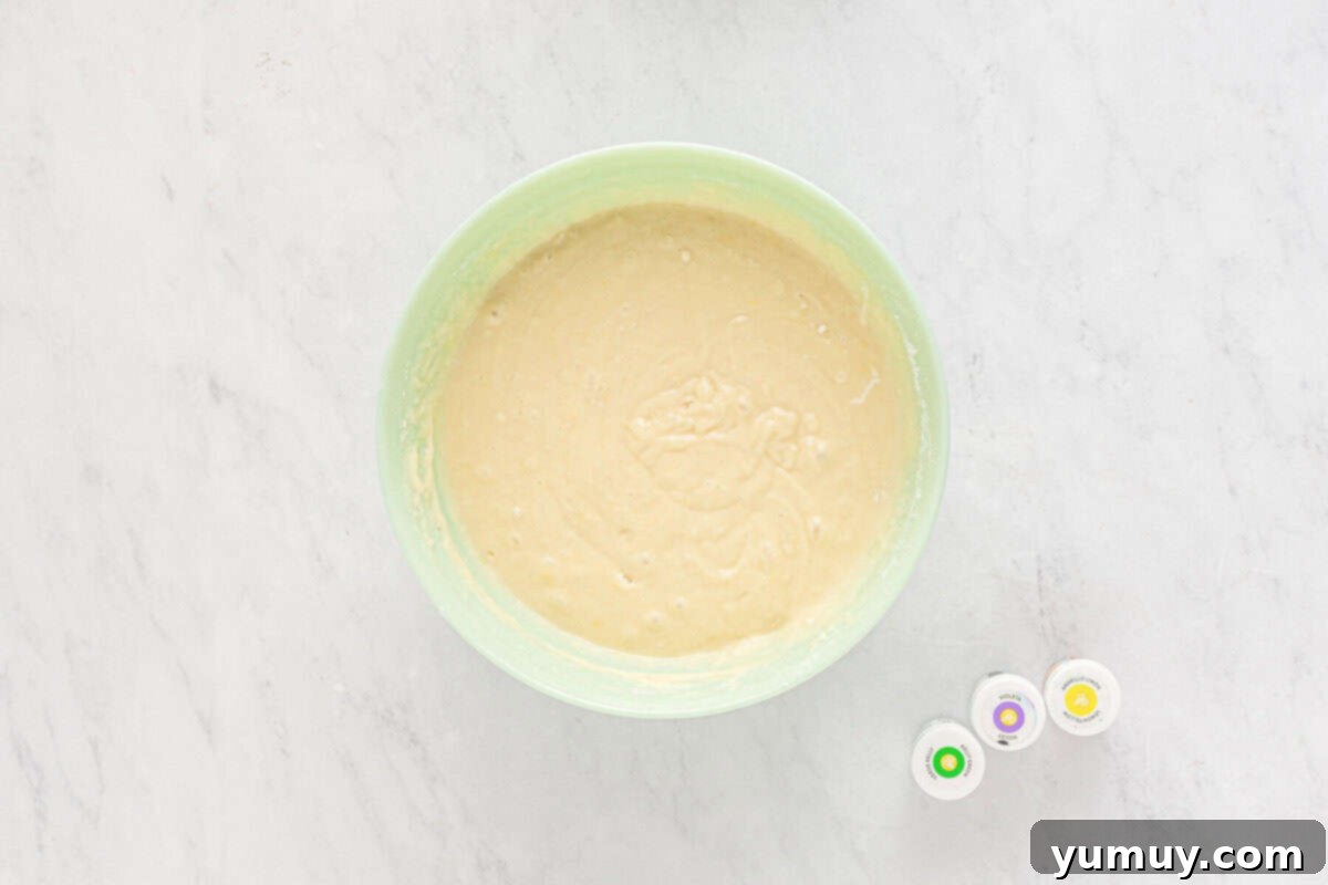 Mardi Gras Birthday Fiesta 15 Mardi Gras birthday cake batter in a light blue bowl, showing its smooth consistency before coloring.