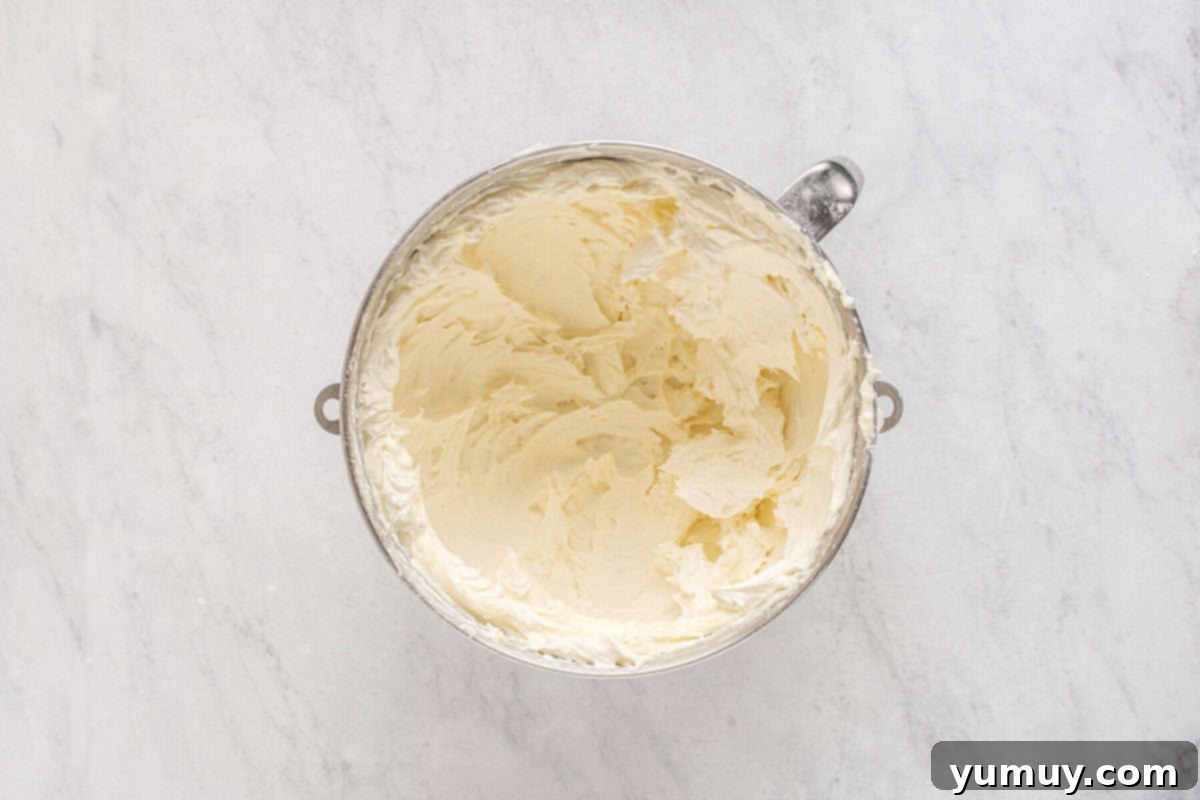 Mardi Gras Birthday Fiesta 18 Smooth and fluffy lemon frosting prepared in a stainless mixing bowl, ready for cake assembly.