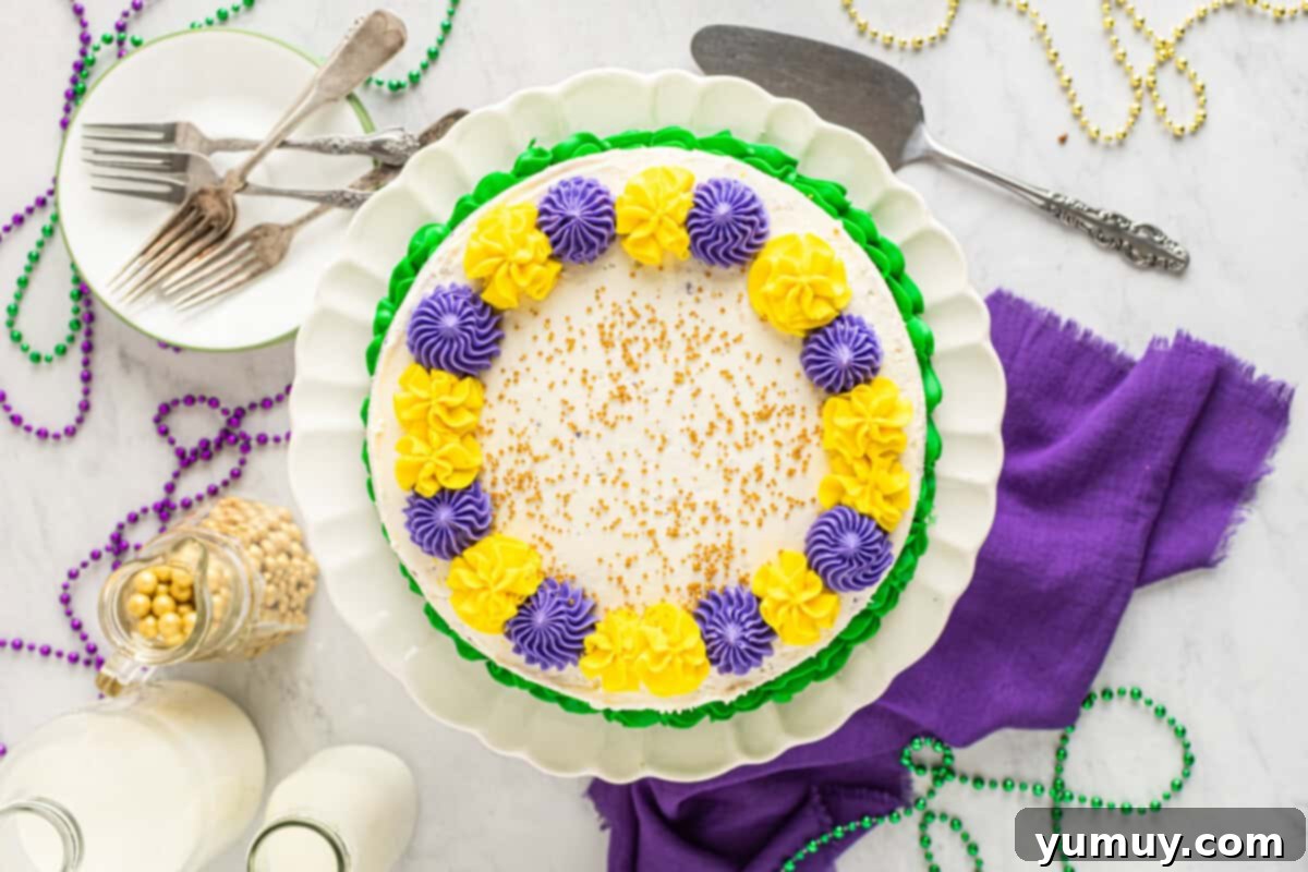Mardi Gras Birthday Fiesta 23 An exquisite overhead view of a fully decorated Mardi Gras birthday cake on a white cake stand, adorned with colorful piped frosting and sprinkles.