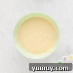 Mardi Gras Birthday Fiesta 6 Mardi Gras birthday cake batter in a light blue bowl, perfectly mixed and ready for coloring.