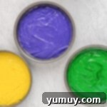 Mardi Gras Birthday Fiesta 8 Yellow, purple, and green Mardi Gras cake batter in separate round cake pans, ready for baking.