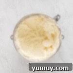 Mardi Gras Birthday Fiesta 9 Lemon frosting in a stainless mixing bowl, showing its creamy, fluffy texture.