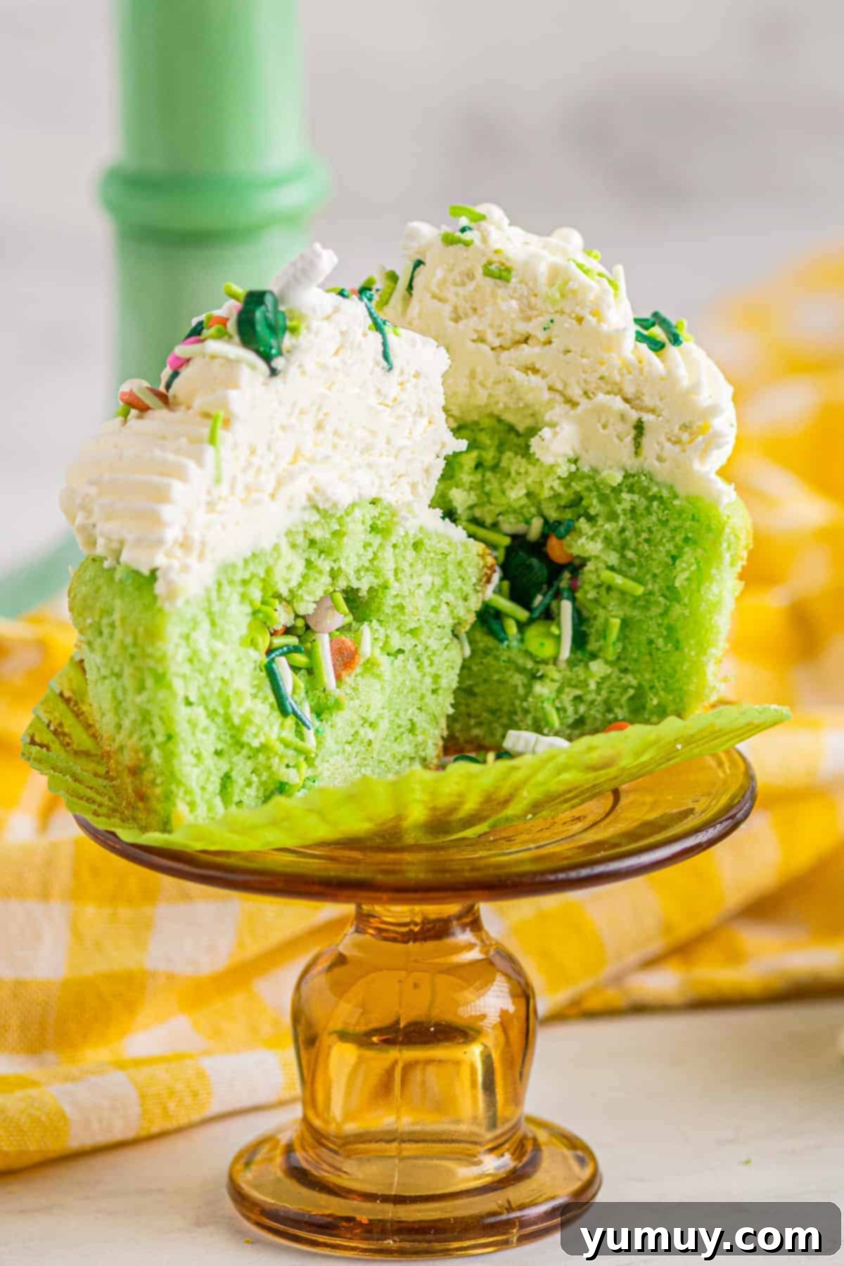 Cinco de Mayo Fiesta Cupcakes 2 cinco de mayo pinata cupcake cut in half, revealing colorful sprinkles inside.