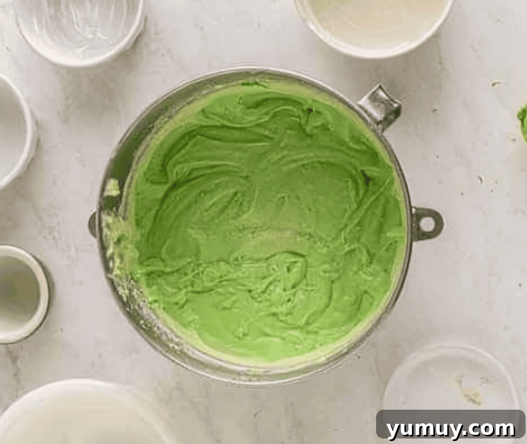 Cinco de Mayo Fiesta Cupcakes 7 bright green cupcake batter in a stainless steel mixing bowl, ready for baking.