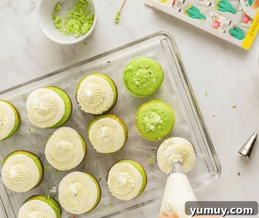 Cinco de Mayo Fiesta Cupcakes 10 frosting green cupcakes on a wire rack, adorned with sprinkles and festive candies.
