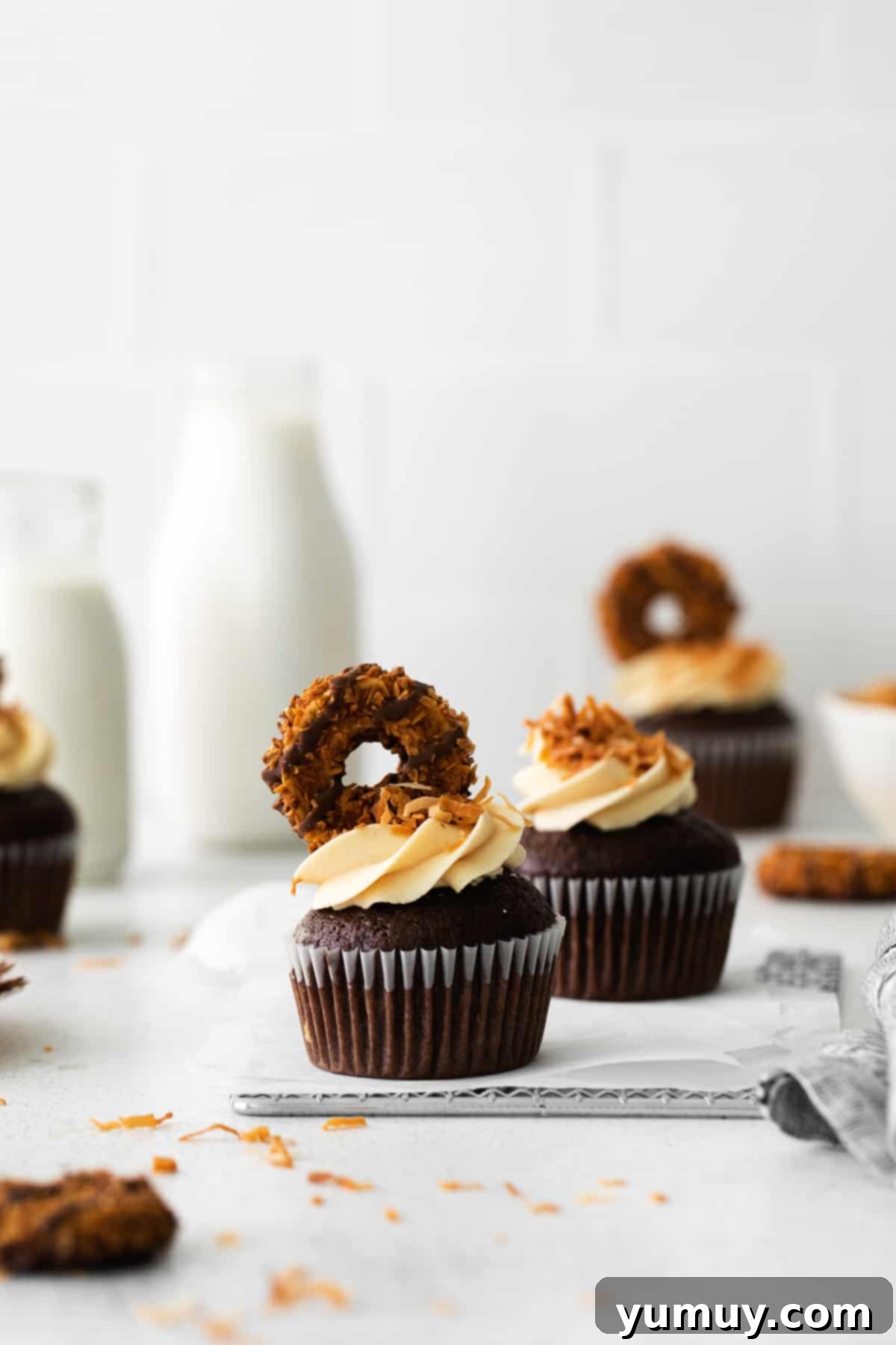Caramel Coconut Chocolate Bliss Cupcakes 2 Indulgent chocolate coconut cupcakes adorned with pieces of Girl Scout Samoa cookies and a drizzle of caramel.