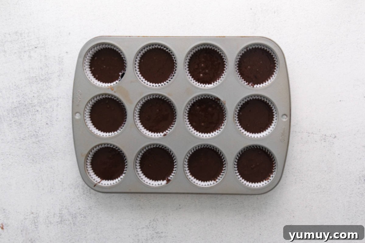 Caramel Coconut Chocolate Bliss Cupcakes 12 Each cupcake liner in the pan is precisely filled with batter, ready to transform in the oven.