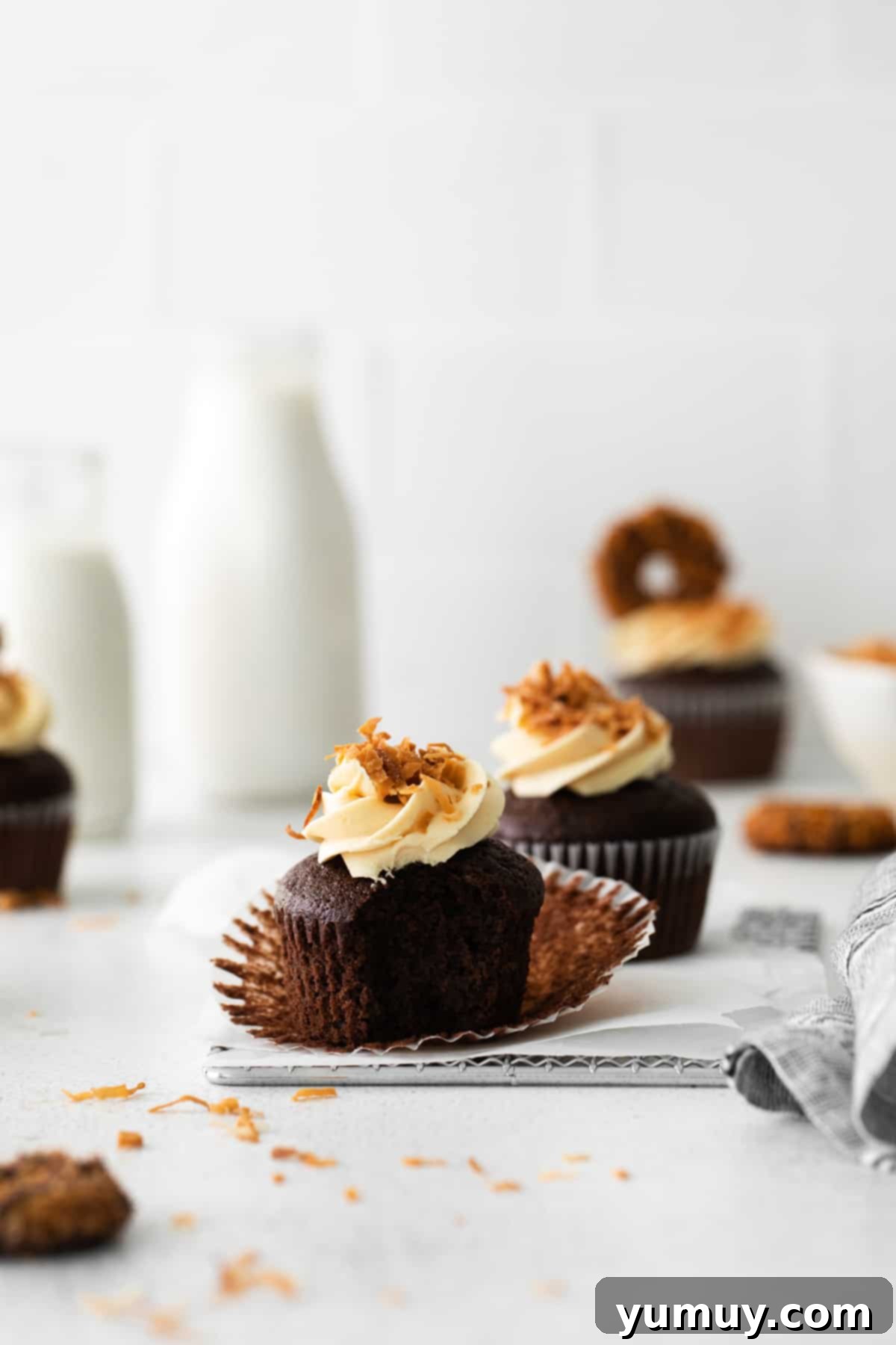 Caramel Coconut Chocolate Bliss Cupcakes 4 A stunning display of Samoa cookie cupcakes artfully arranged on a tabletop, inviting indulgence.