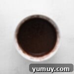 Caramel Coconut Chocolate Bliss Cupcakes 6 Rich chocolate batter is smoothly mixed in a large bowl, ready for baking.