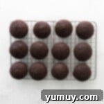 Caramel Coconut Chocolate Bliss Cupcakes 8 Freshly baked cupcakes resting on a wire rack, cooling down before frosting.