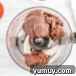 Thin Mint cookie dough forming a cohesive ball inside a food processor bowl.