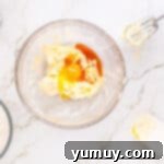 Heart Kiss Cookies 7 wet ingredients for heart thumbprint cookies in a glass bowl.