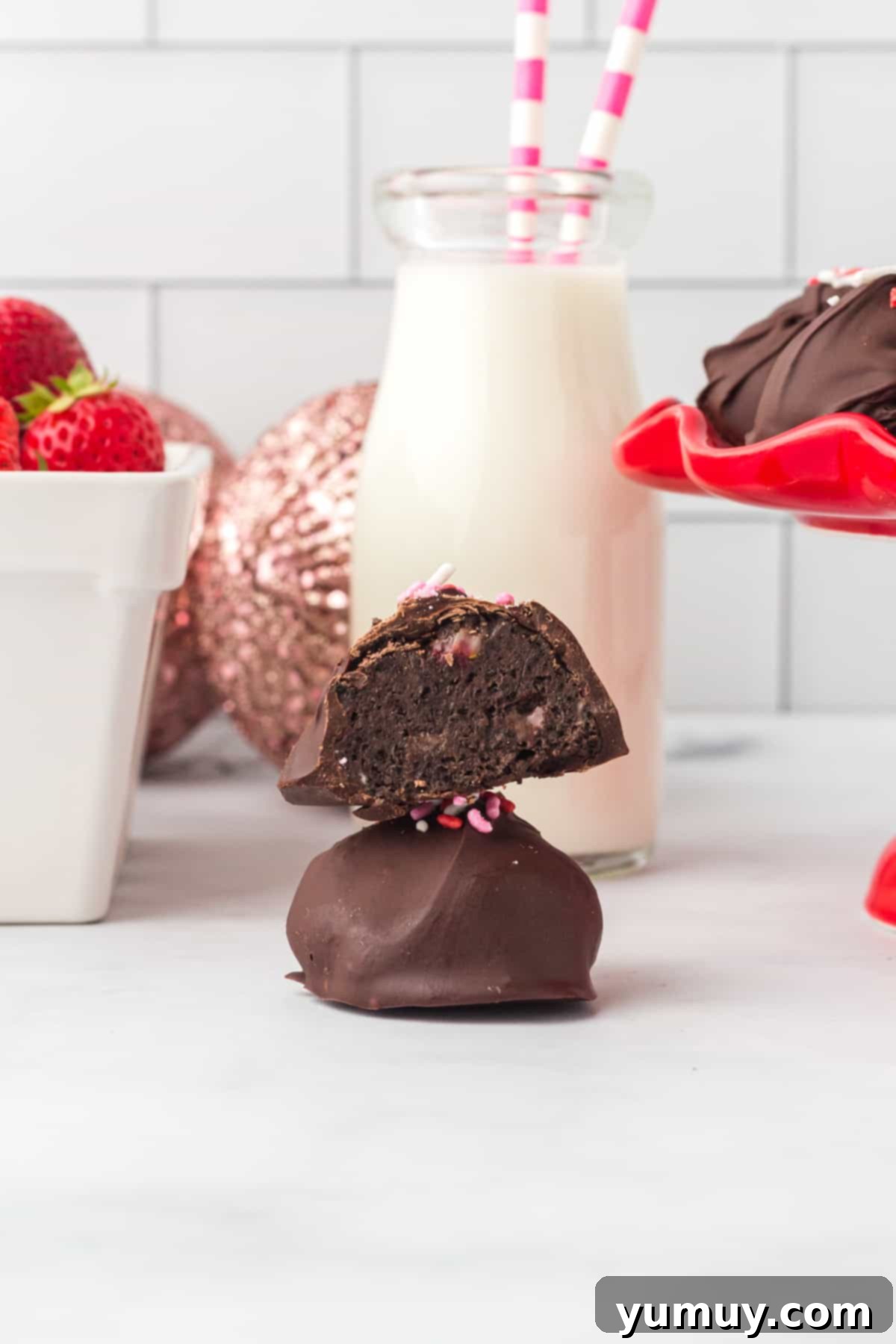 Decadent chocolate-dipped strawberry truffles artfully stacked, ready to be enjoyed.