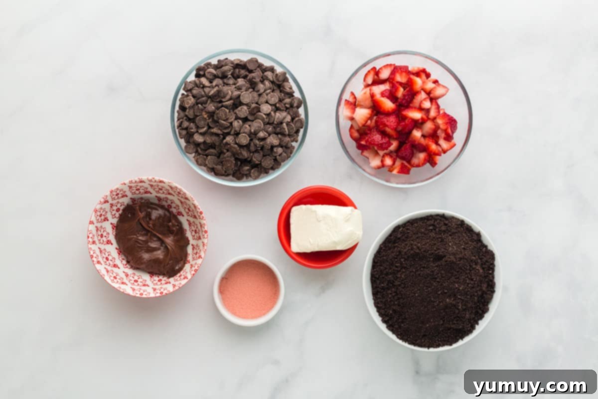 A delightful spread of fresh ingredients for making strawberry truffles, including Oreos, cream cheese, and strawberries.