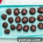 Dipping truffles in melted chocolate and adding sprinkles for decoration.