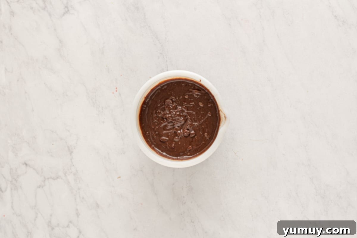 chocolate ganache in a white bowl.