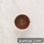 chocolate ganache in a white bowl.